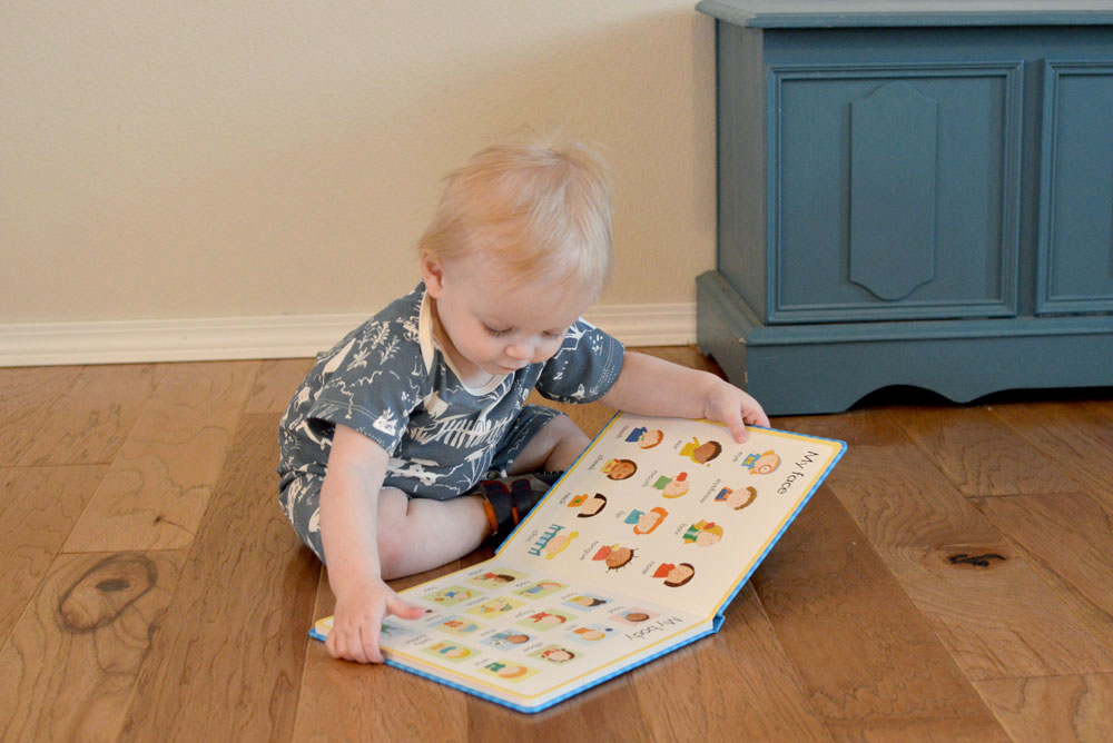 baby boy reading a first word Usborne book