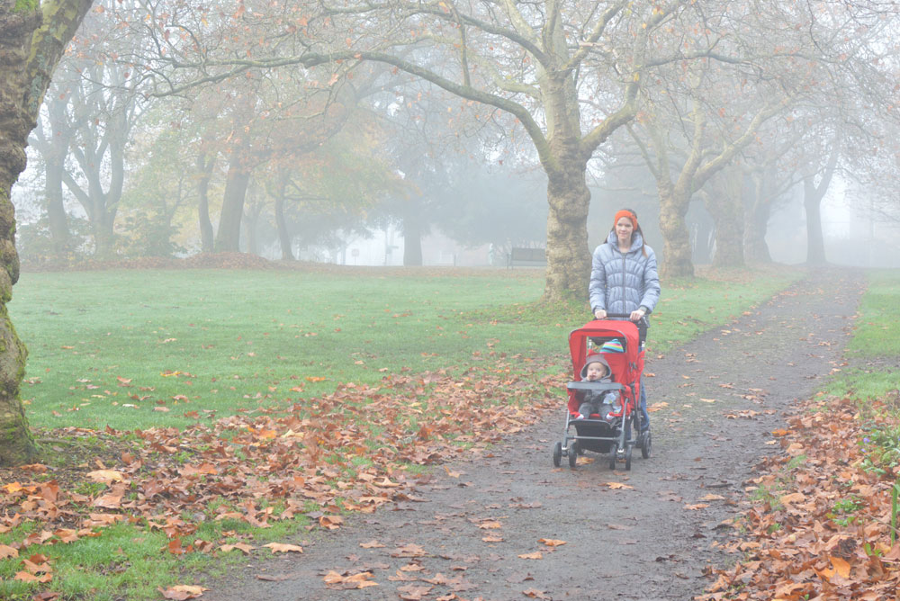walking through a park with the Joovy ultralight stroller
