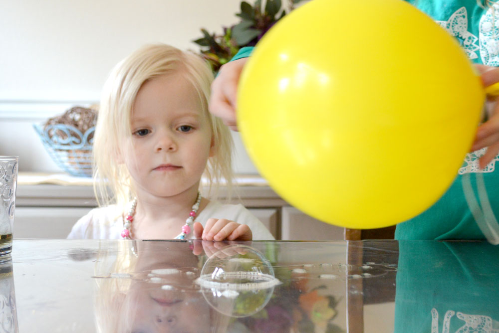 Static electricity kids activity with soap bubbles