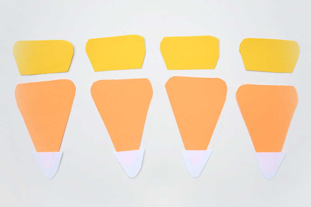 You can easily make your own candy corn pennant banner in a few simple steps