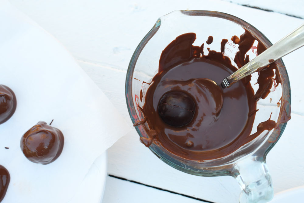 dipping truffle centers in melted chocolate